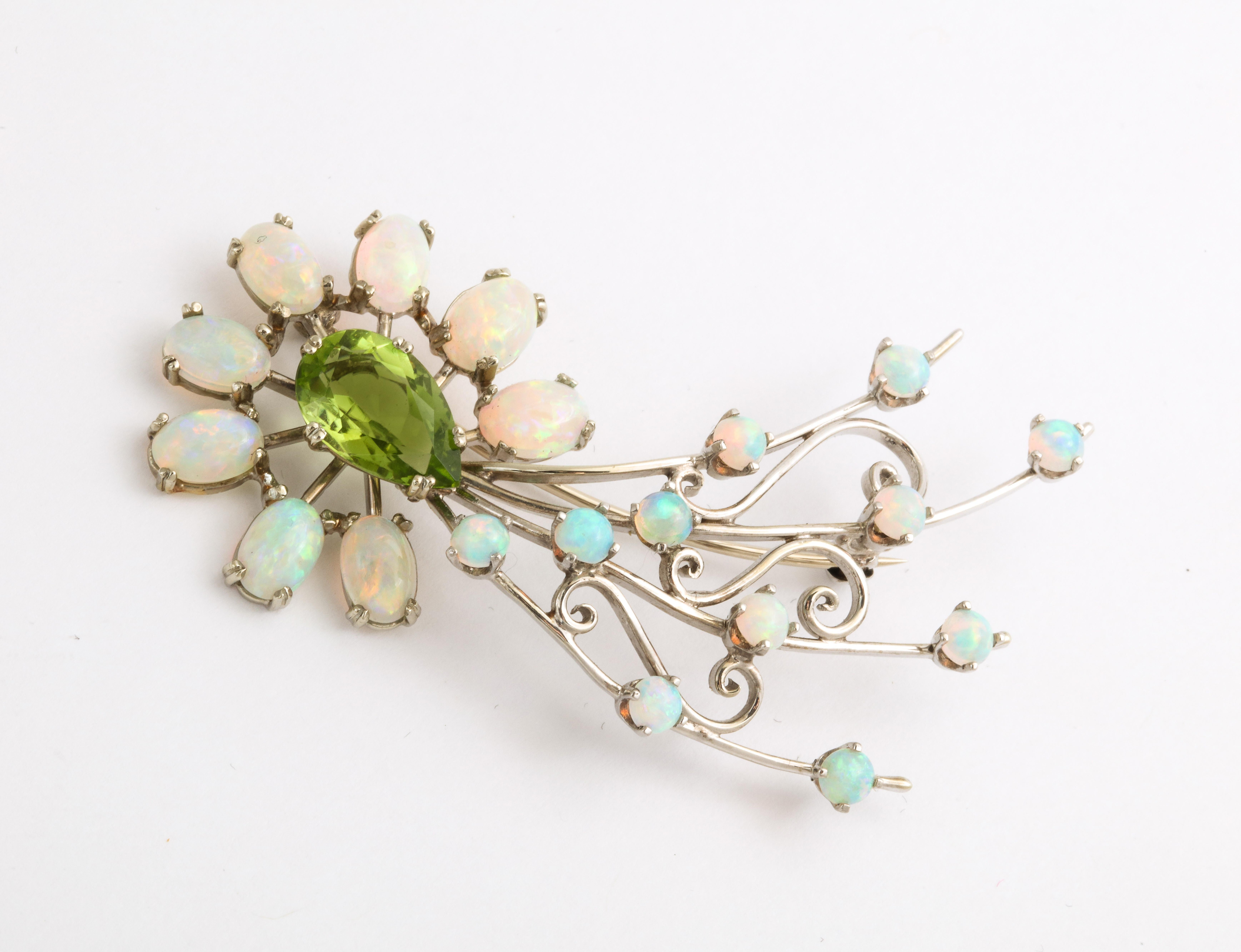 A distinctive 18 Kt gold comet brooch, larger than most and brilliant with opals around the peridot head and the peacock like tail. Be it in the heavens or on you lapel, dress, hat or sweater it is heavily drama. Haleys Comet was last seen from