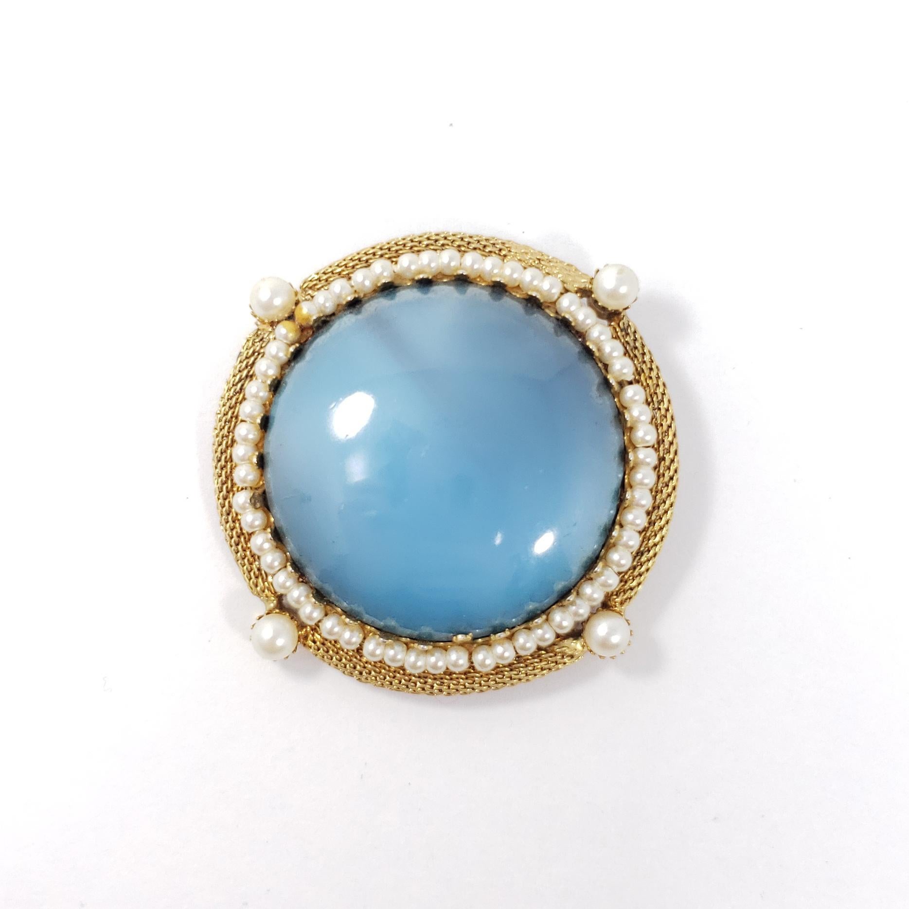 A sophisticated vintage set, featuring gold-tone mesh bezels, accented with faux pearls and centerpiece faux larimar cabochons. Includes a single pin brooch and a pair of clip-on earrings.

Gold-tone. Vintage, 20th century.

Brooch dimensions: 2