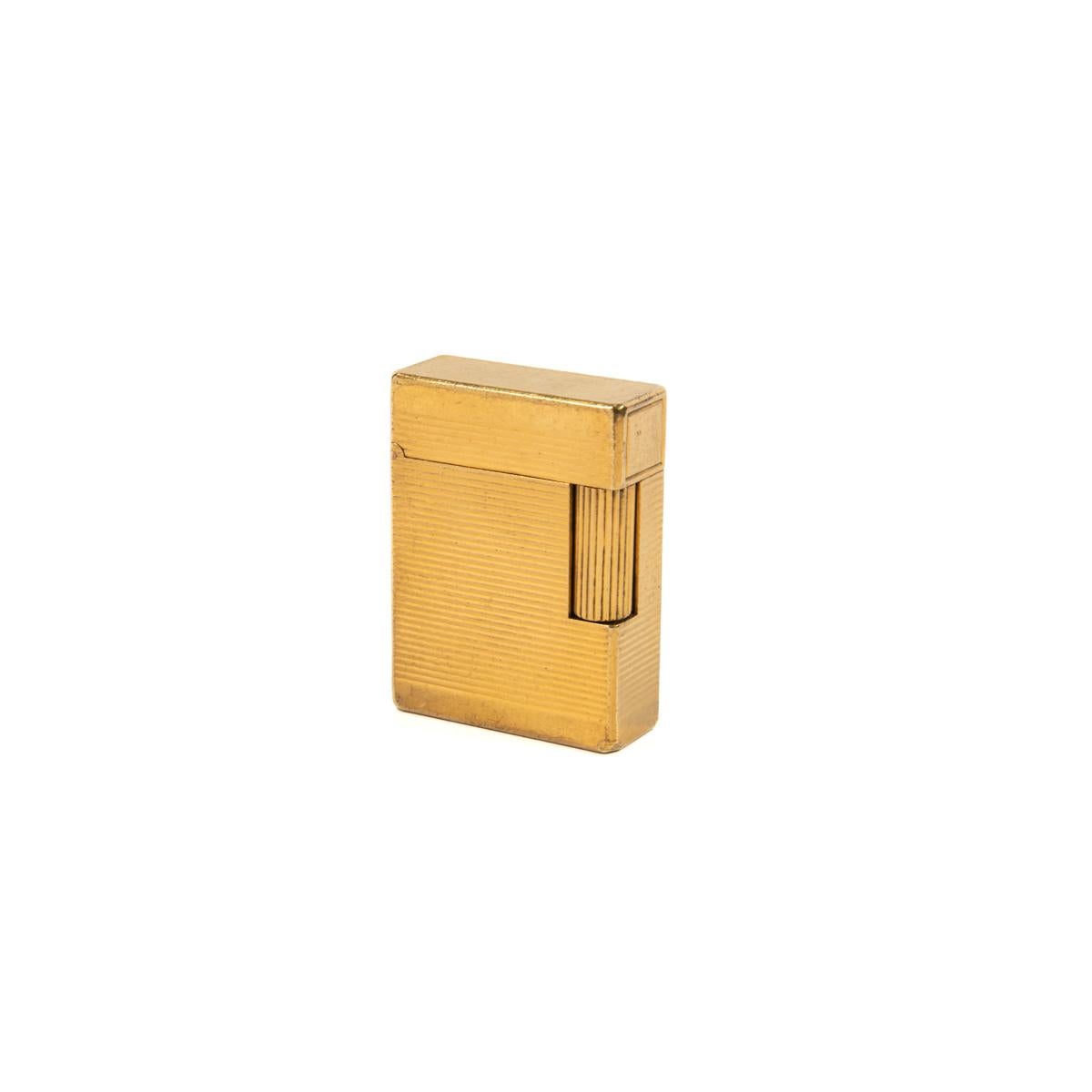 Vintage Gold Plated Ligne 1 ST Dupont Lighter 1970s

The iconic S.T. Dupont name is known for quality, well-made cigarette lighters and other luxury implements. The company’s origin can be traced to Simon Tissot-Dupont opening his workshop shop in