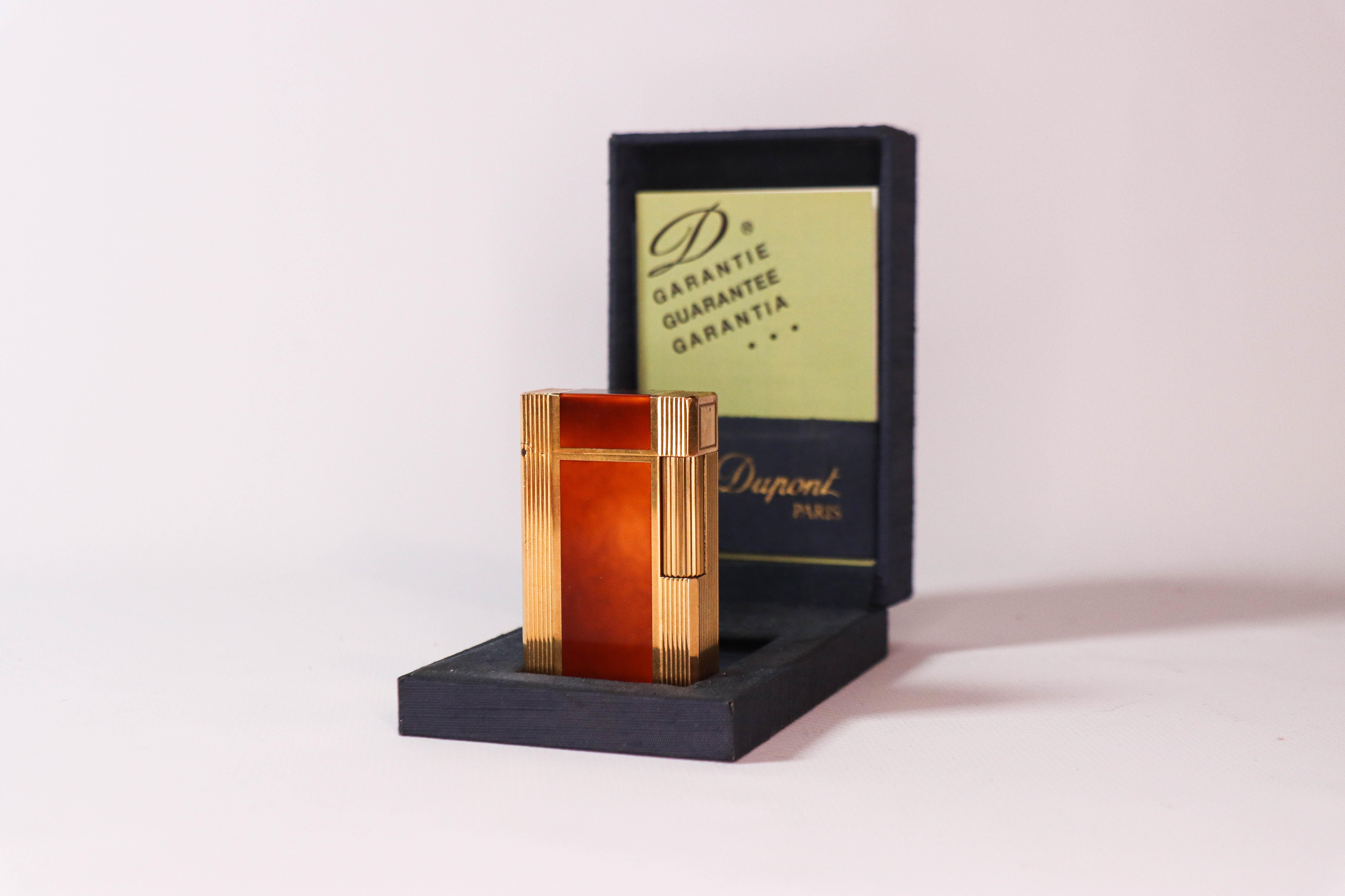 Vintage Gold Plated Ligne 1 BR ST Dupont Lighter Chinese Laque de Chine 1980s In Box

The iconic S.T. Dupont name is known for quality, well-made cigarette lighters and other luxury implements. The company’s origin can be traced to Simon