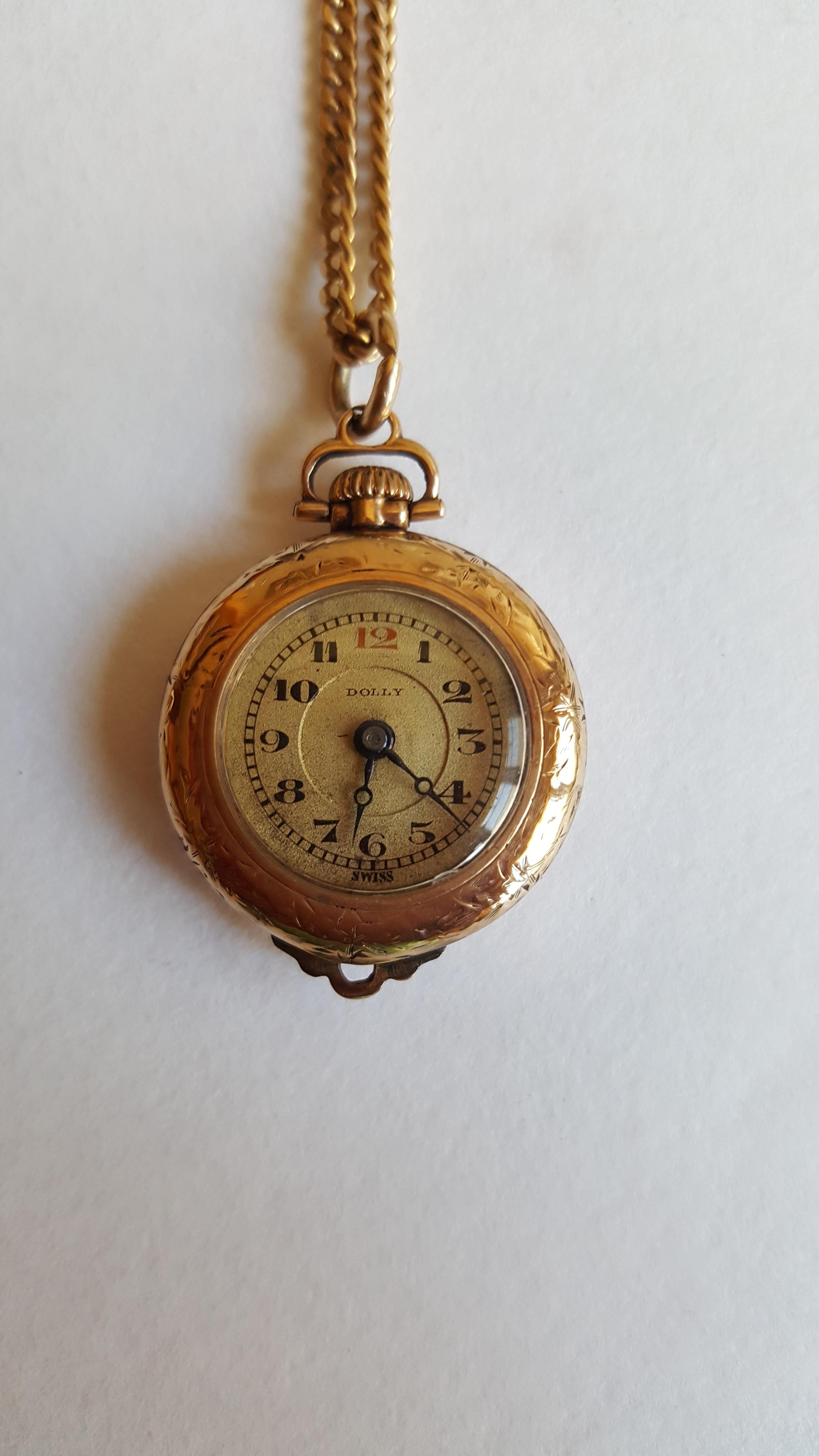 Vintage Gold Plated Pendant Watch, Dolly Brand, Working, 15 Jewel, 2 Adjusted, Swiss Made, Ariston  Watch Co. Produced by Illinois Watch Co. 
Beautiful vintage from the 1920's,  24 mm in diameter, the size of a quarter.  18 in chain. 9 mm thick. 