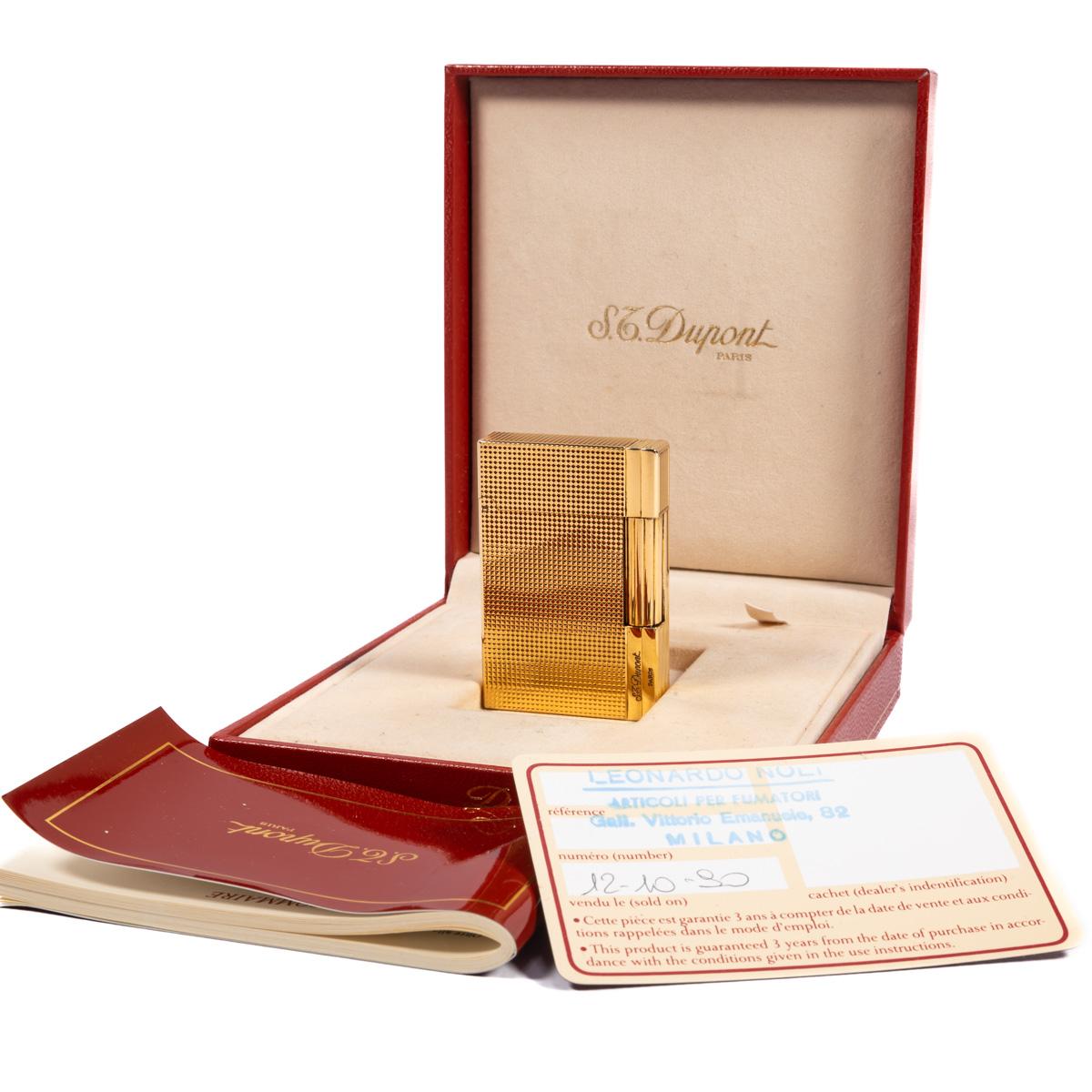 Vintage Gold Plated ST Dupont Gatsby Lighter 1990s In Box

The iconic S.T. Dupont name is known for quality, well-made cigarette lighters and other luxury implements. The company’s origin can be traced to Simon Tissot-Dupont opening his workshop