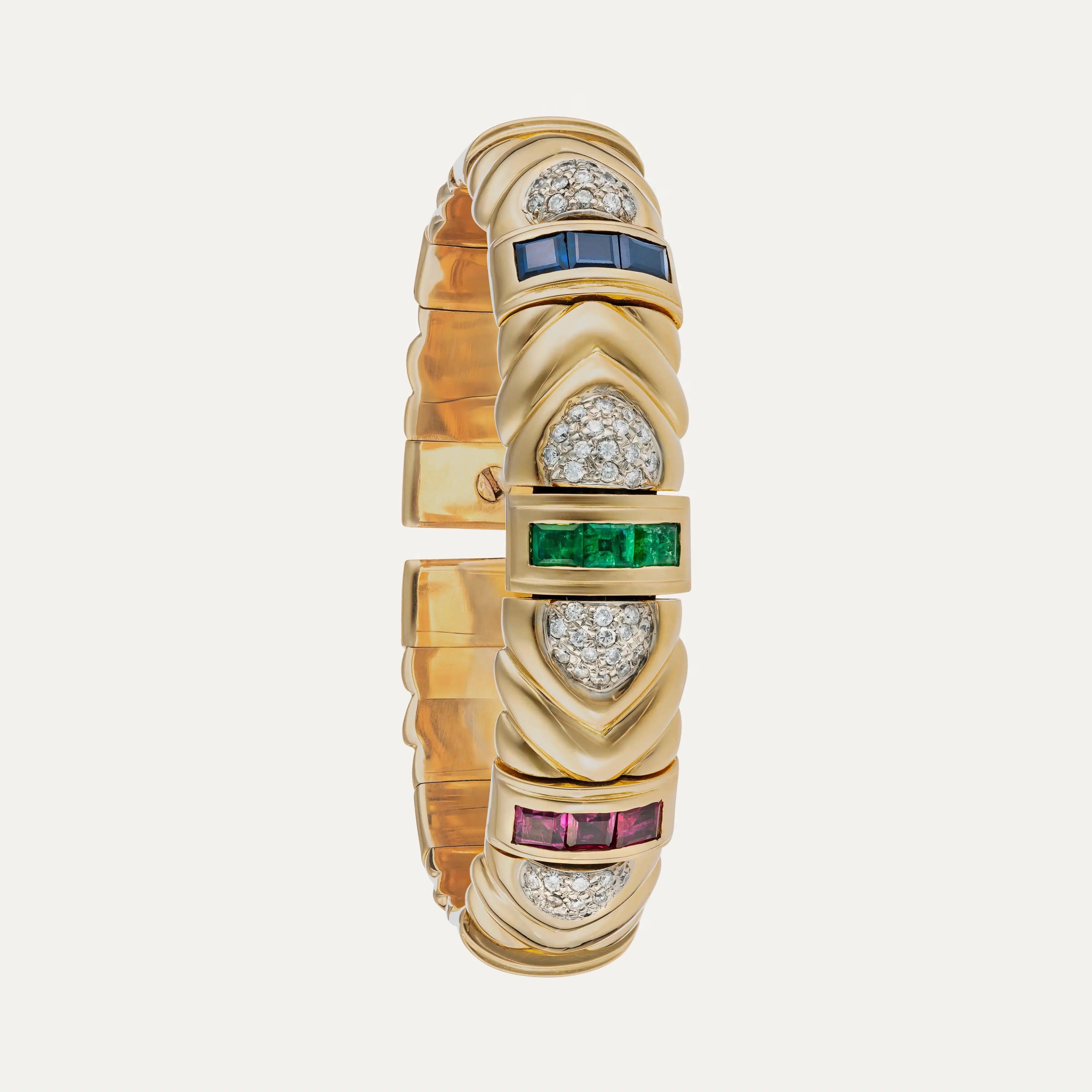 Vintage Portuguese Yellow Gold Rigid Bracelet with Sapphires, Emeralds, Rubies & Diamonds

Crafted in richly 19.2K yellow gold — a high-purity alloy traditionally used in Portuguese fine jewelry — this striking rigid bracelet blends classic luxury