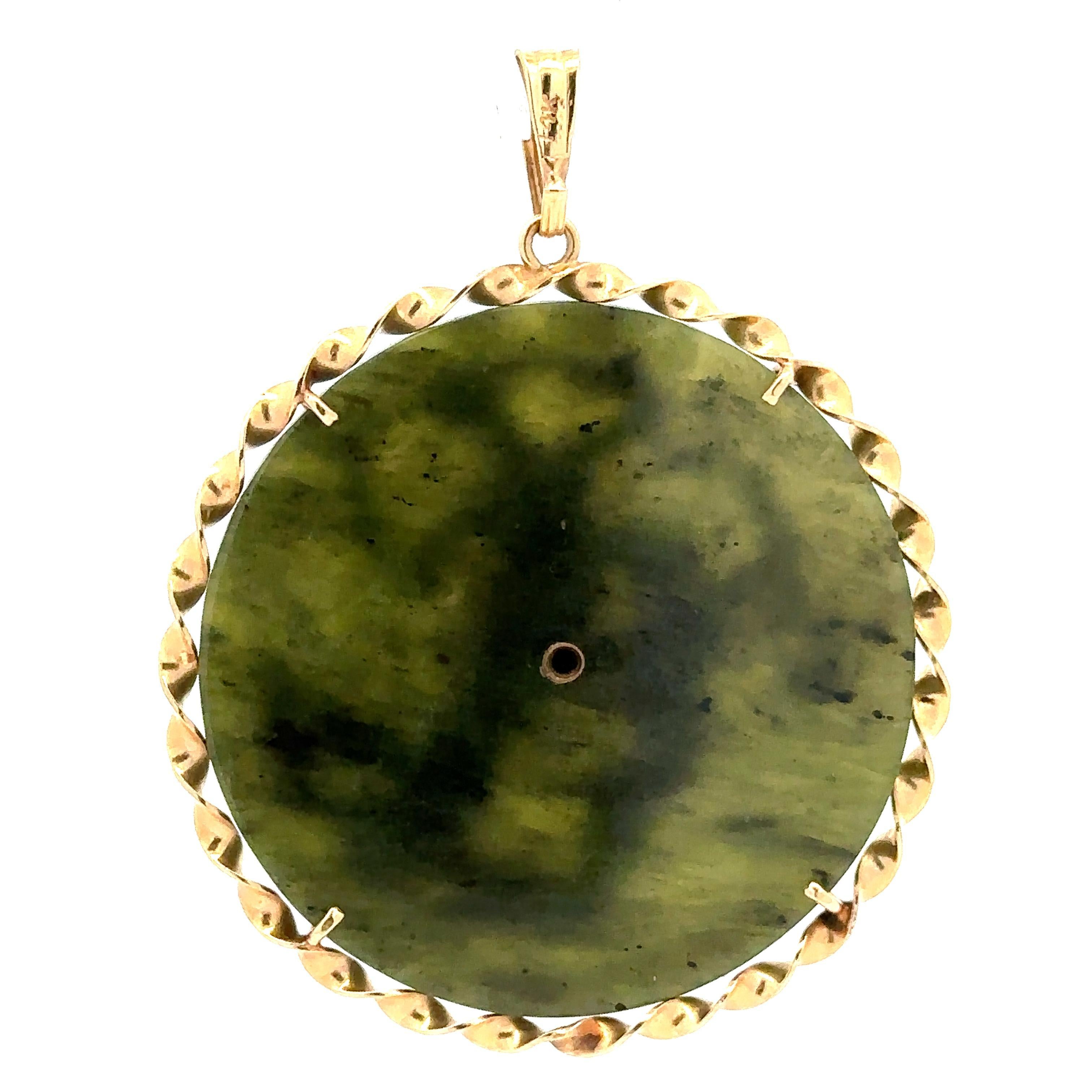 --Stone(s):--
(1) Natural Genuine Jade - Round Cut - Prong Set - Green Color - 44.7mm (approx.)

Material: 14K Solid Yellow Gold
Weight: 20.56 Grams
Pendant Diameter: 49.5mm (1.9