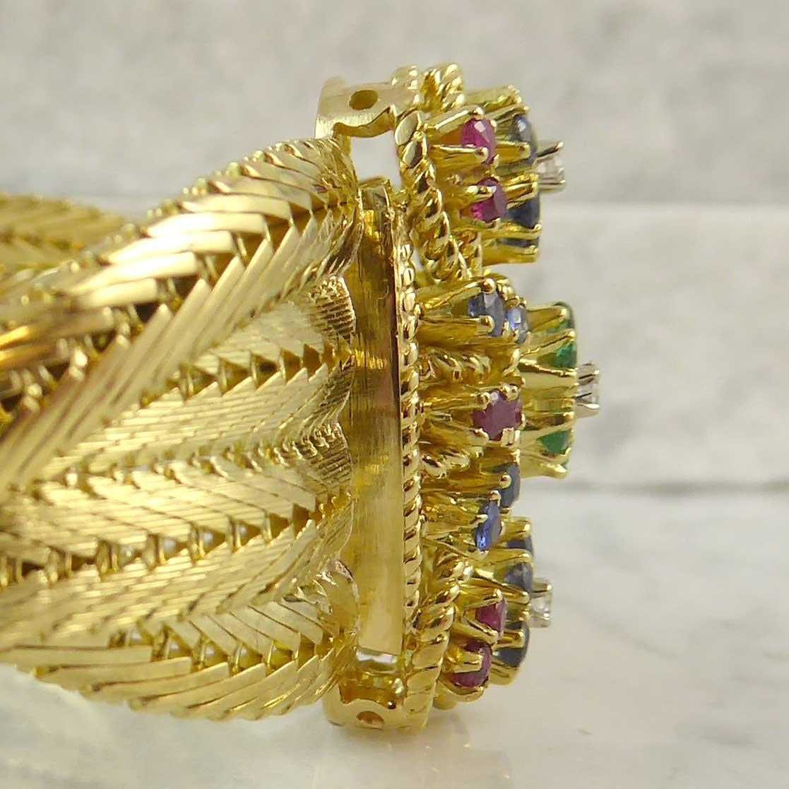 A fabulous vintage bracelet fashioned from four rows of fox-tail link gold strands: two strands forming the central section with two strands (one to each side) wrapped around in a plaited style.  The bracelet fastens at the front by way of a raised