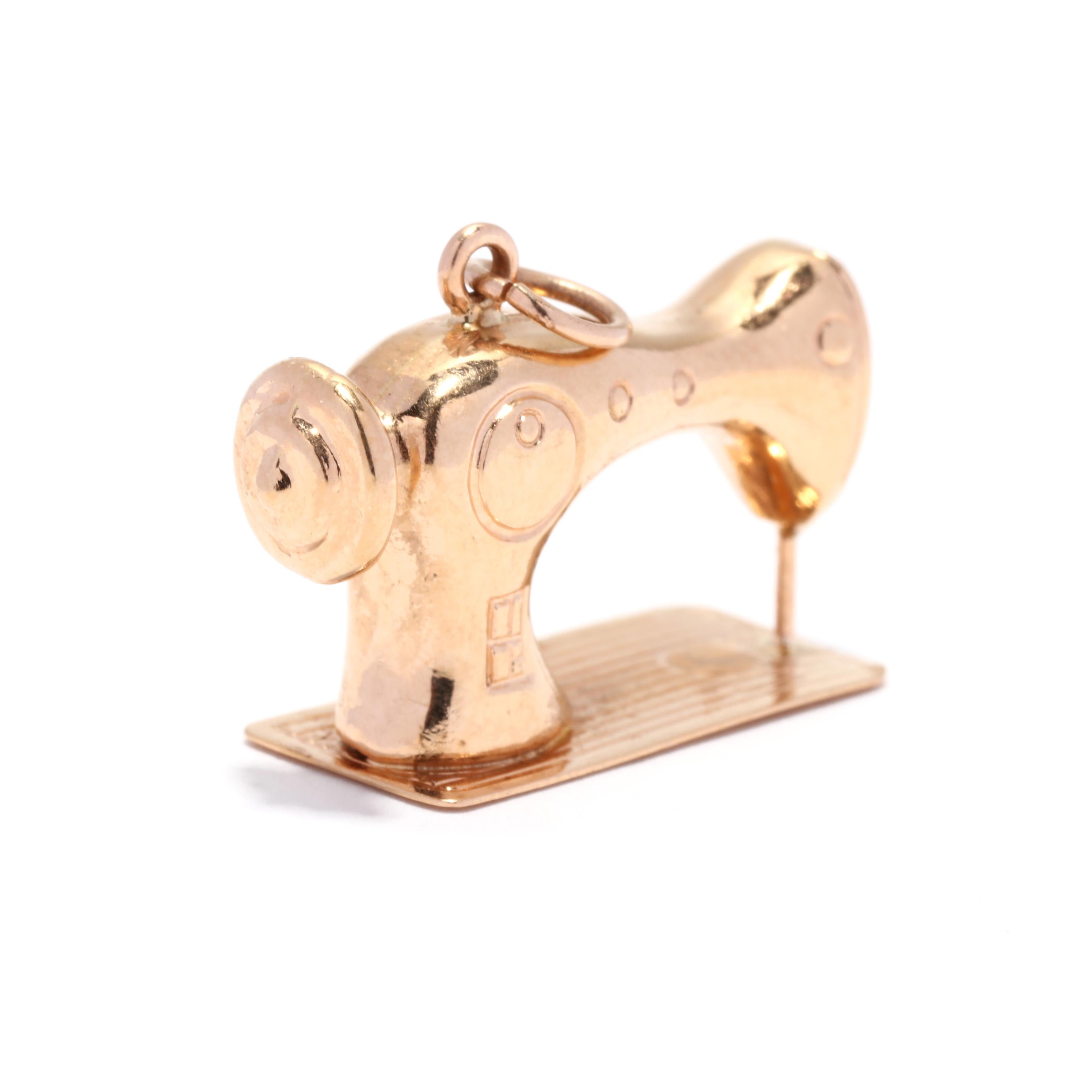 A vintage 18 karat yellow gold sewing machine charm. This large charm features a vintage sewing machine motif with engraved detailing and with a rose gold tint to the metal.

Length: 1 in.

Width: 3/4 in.

Weight: 2.2 dwts. / 3.42 grams

Stamps: 750