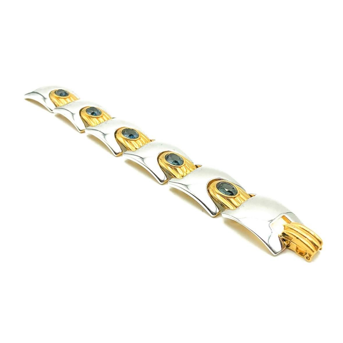 A stunning Vintage Modernist Sapphire Bracelet. Featuring weighty modernist style links with contrasting gold and silver sections finished with faceted sapphire crystal stones. Crafted in high quality gold plated and silver or rhodium plated metals.