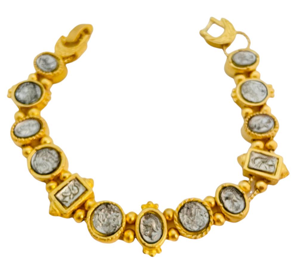DETAILS
unsigned
gold tone with silver coins
vintage designer runway bracelet

MEASUREMENTS  
7.5