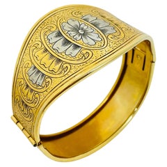 Braccialetto a cerniera vintage in oro e argento, con fiori incisi, di design