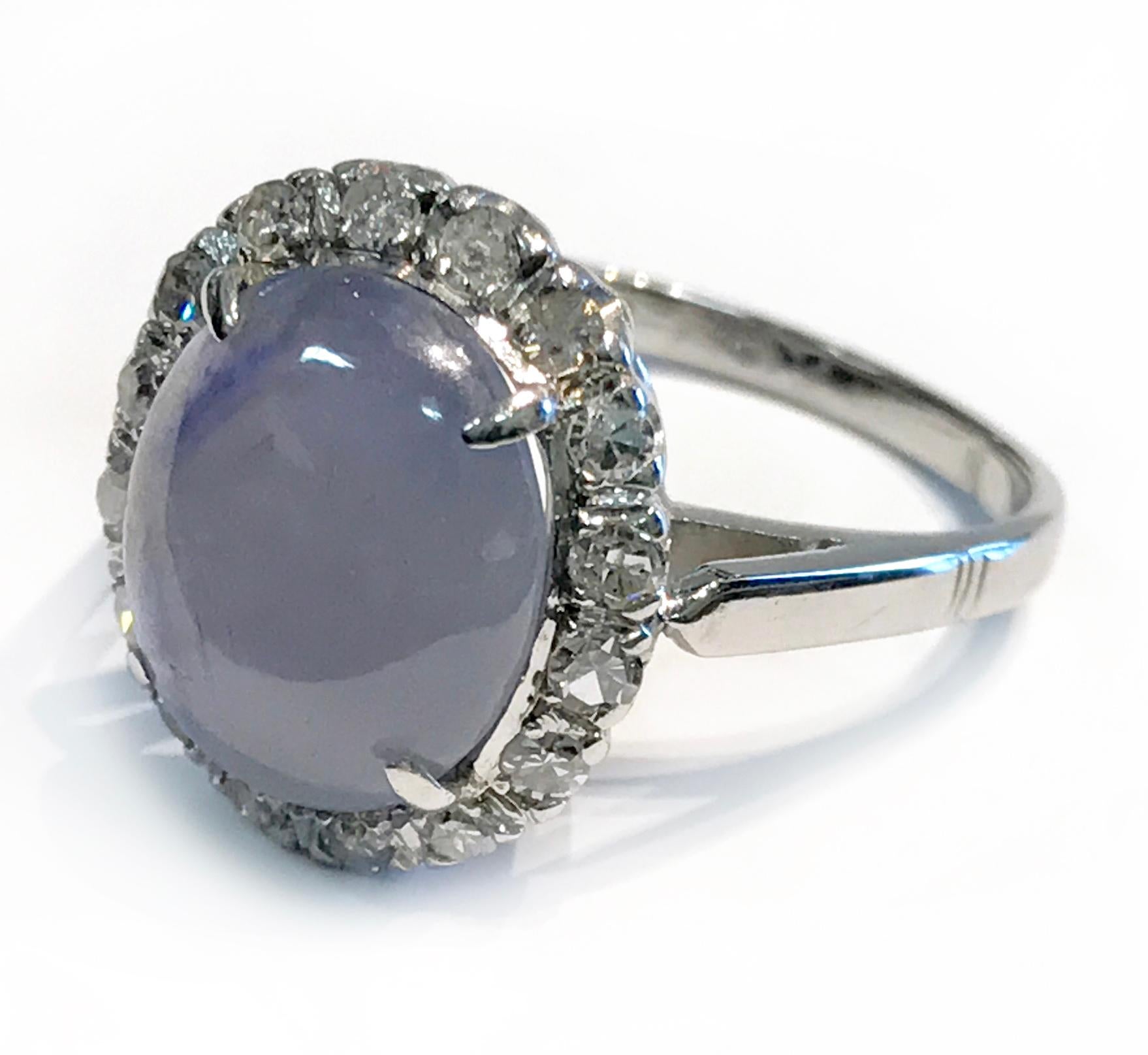 Vintage 14k White Gold Star Sapphire with Diamond Halo, 0.32 total carat weight. The natural Sapphire is 11.49mm x 9.64mm x 8.2mm, 8.17 carat, four prong set. The star has a good presence with light. The Diamond halo consists of sixteen single-cut