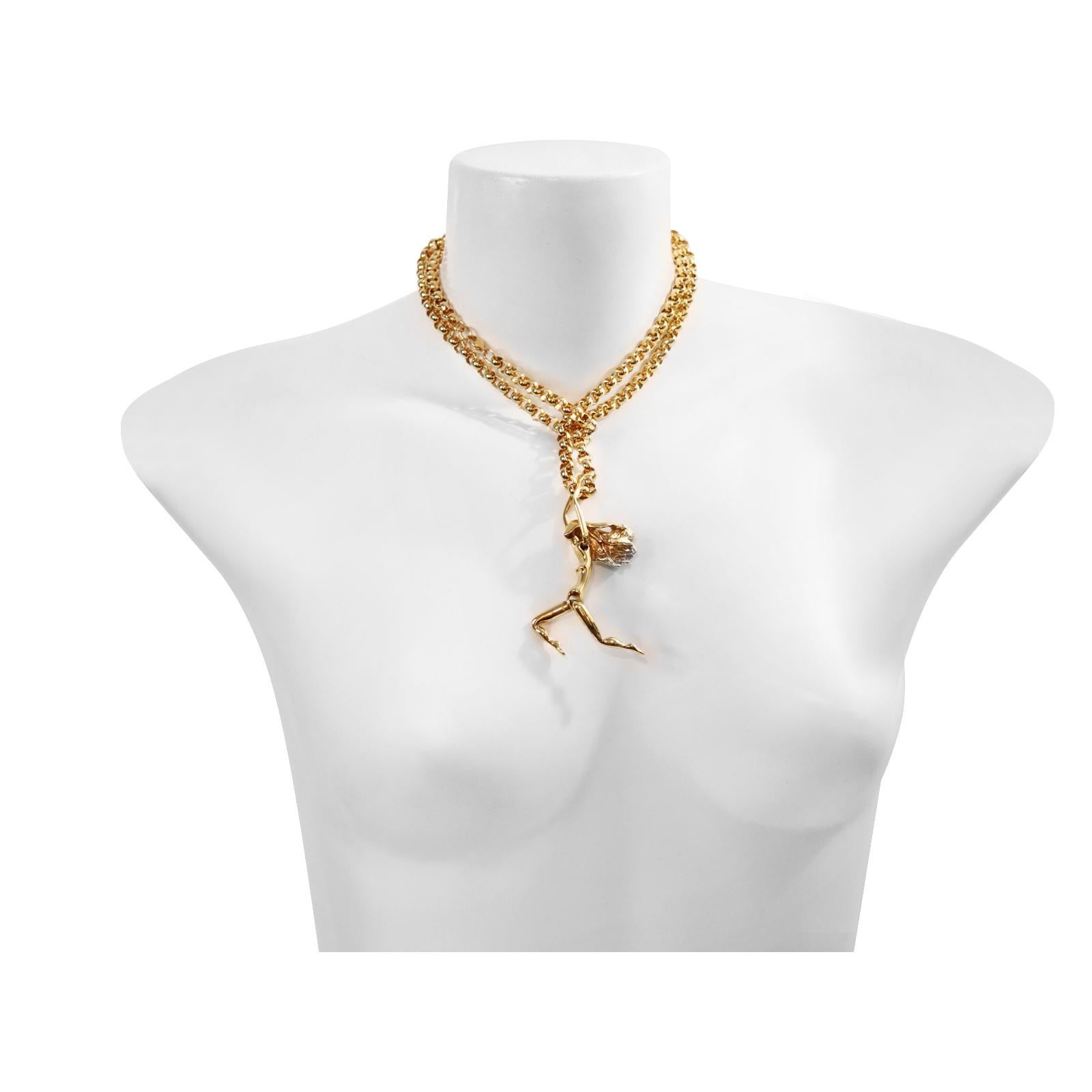 Collana Acrobatic Lady vintage in tonalità oro, CIRCA anni '80.  È coinvolgente e si muove. Il suo corpo si muove attraverso le braccia e le gambe sono mobili. 

La catena è lunga 36 pollici, quindi puoi indossarla lunga, avvolta intorno al collo o