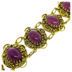 Bracelet vintage avec cabochons en verre d
améthyste et tonalité dorée