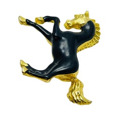 Vintage gold tone black enamel horse figural designer brooch