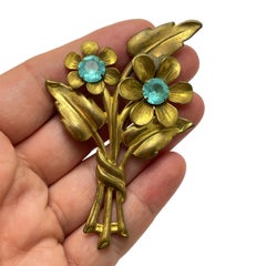 Vintage gold tone blue rhinestone flower designer brooch