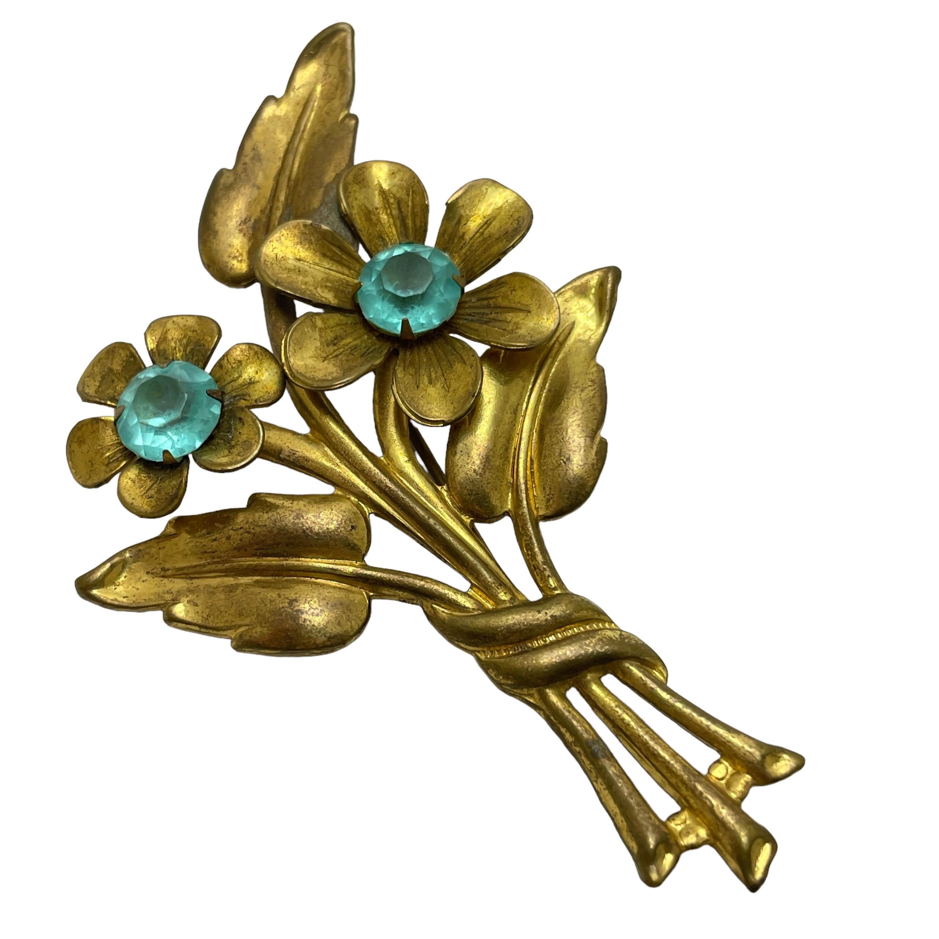 Women's or Men's Vintage gold tone blue rhinestone flower designer brooch For Sale