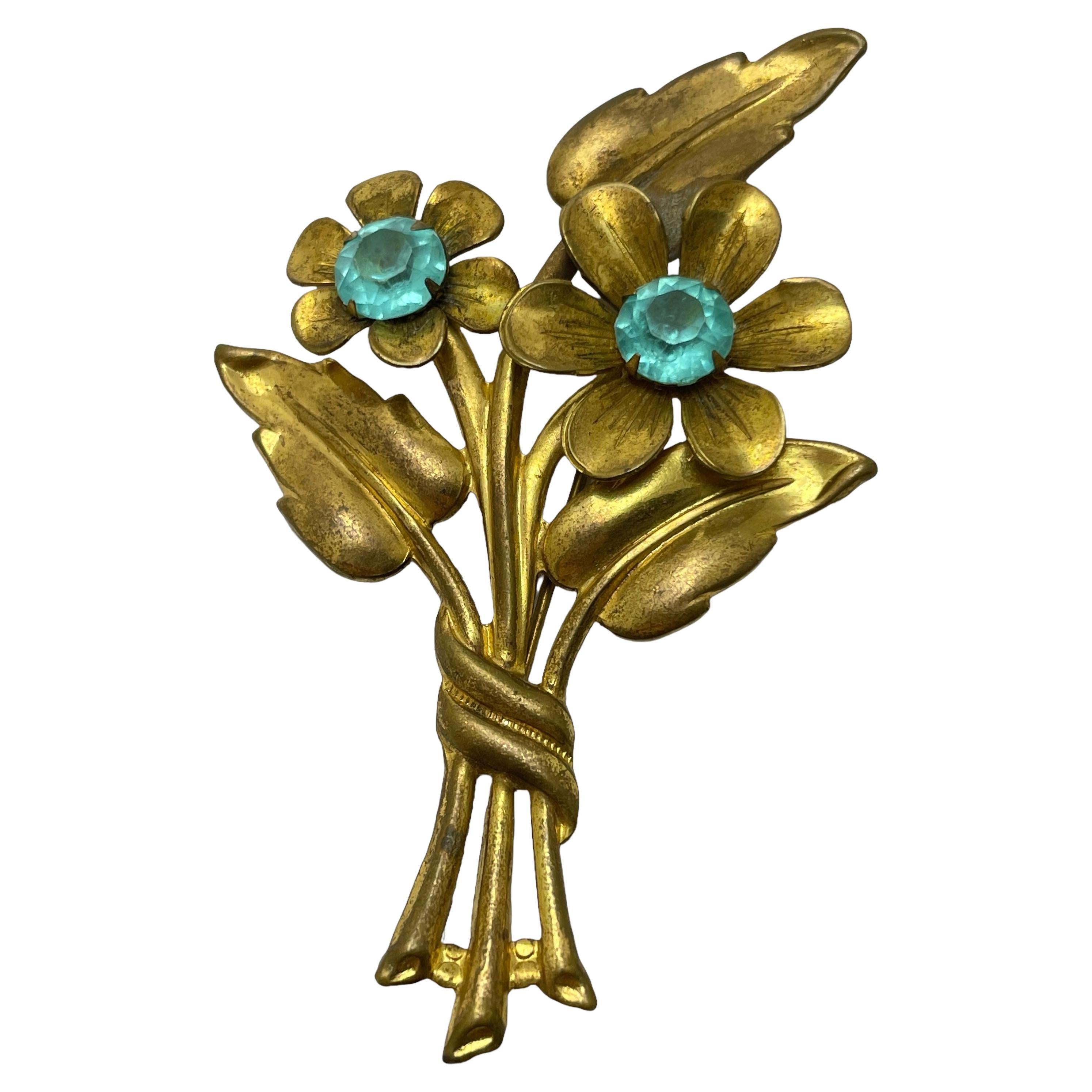 Vintage gold tone blue rhinestone flower designer brooch For Sale