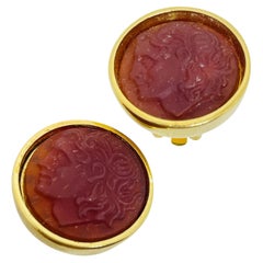 Orecchini a clip etruschi in vetro corniola tono oro d
epoca