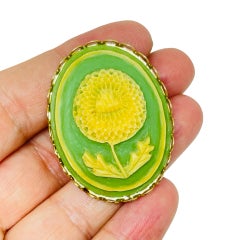 Vintage gold tone carved celluloid flower cameo brooch