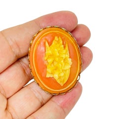 Vintage gold tone carved celluloid flower cameo brooch
