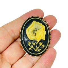 Vintage gold tone carved celluloid flower cameo brooch