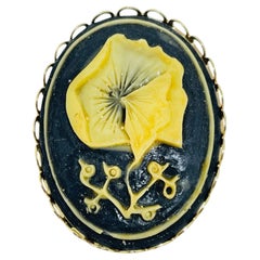 Vintage gold tone carved celluloid flower cameo brooch