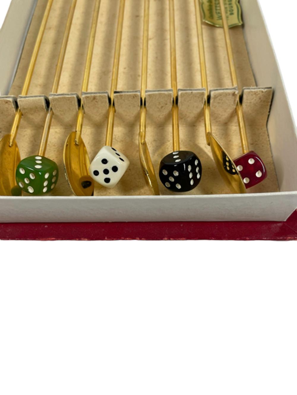 Vintage Bakelite dice topped gold-toned cocktail/drink stirrers in their original packaging. Each stir spoon with different color Bakelite dice tops, some are translucent and opaque versions of the same color. Package marked 