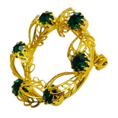 Vintage gold tone emerald green rhinestones designer brooch