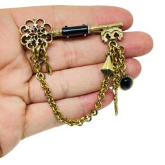 Vintage gold tone enamel key dangle charms designer brooch
