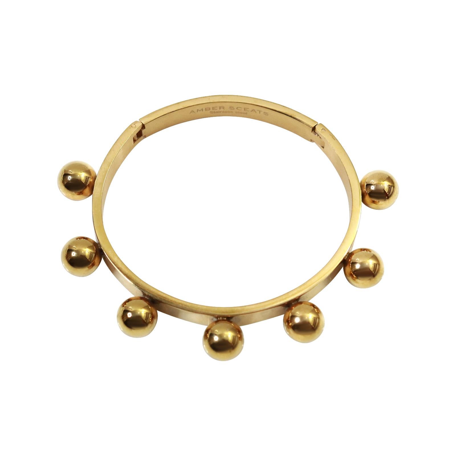 Vintage Gold Tone Heavy Bracelet With Fixed Balls Circa 1990s.  This bracelet reminds me of what a Cartier would look like or something to that level.  It is substantial and well made. It has a groove and a hidden tongue that pulls tight to lock it