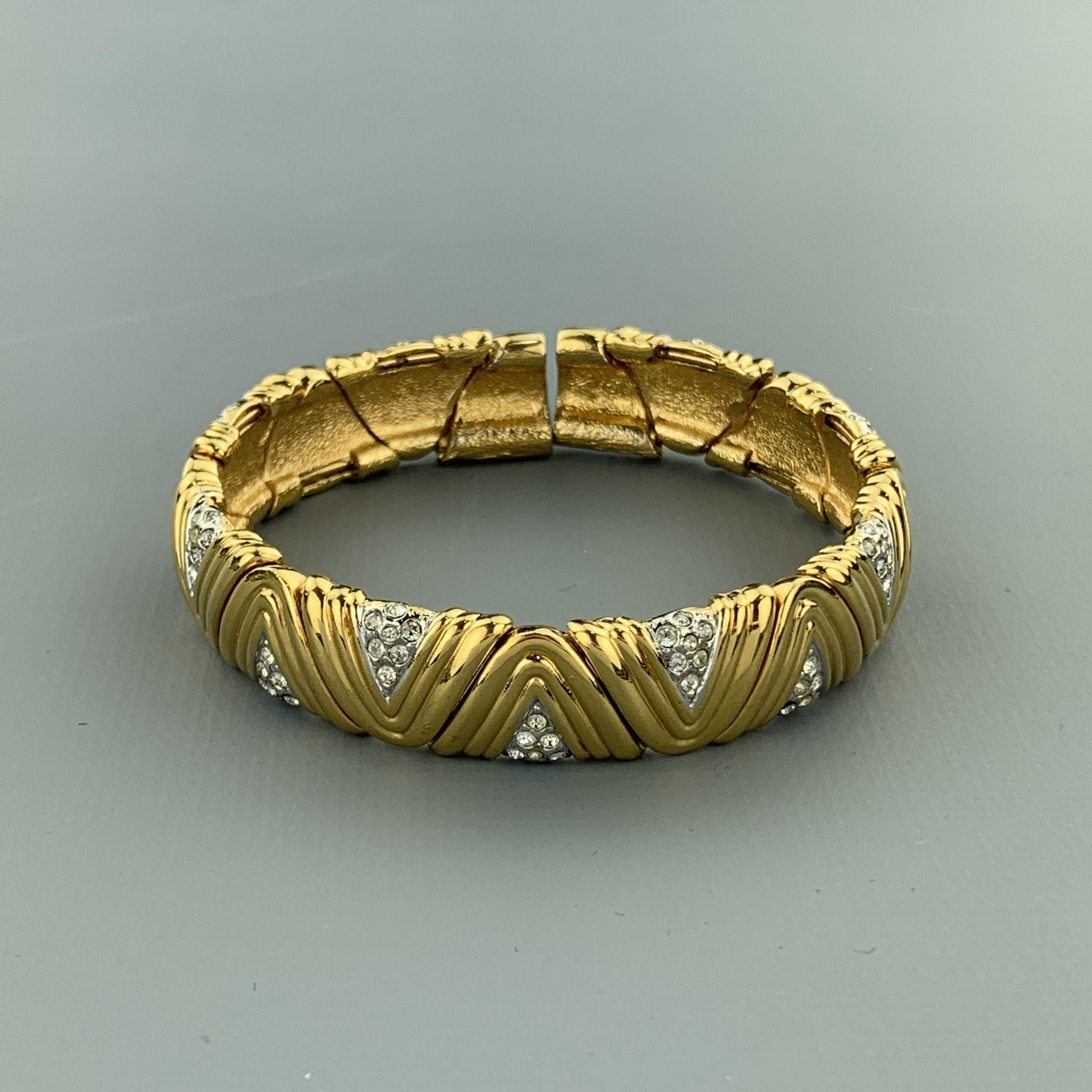 Vintage cuff bracelet comes in yellow gold tone textured metal with silver tone rhinestone panels and slit back.
 
Excellent Pre-Owned Condition.
 
Fits: 7 in.
SKU: 96312
Category: Bracelet

More Details
Brand: VINTAGE
Color: Gold Tone
Material: