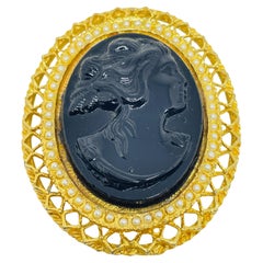 Vintage gold tone molded glass black cameo brooch