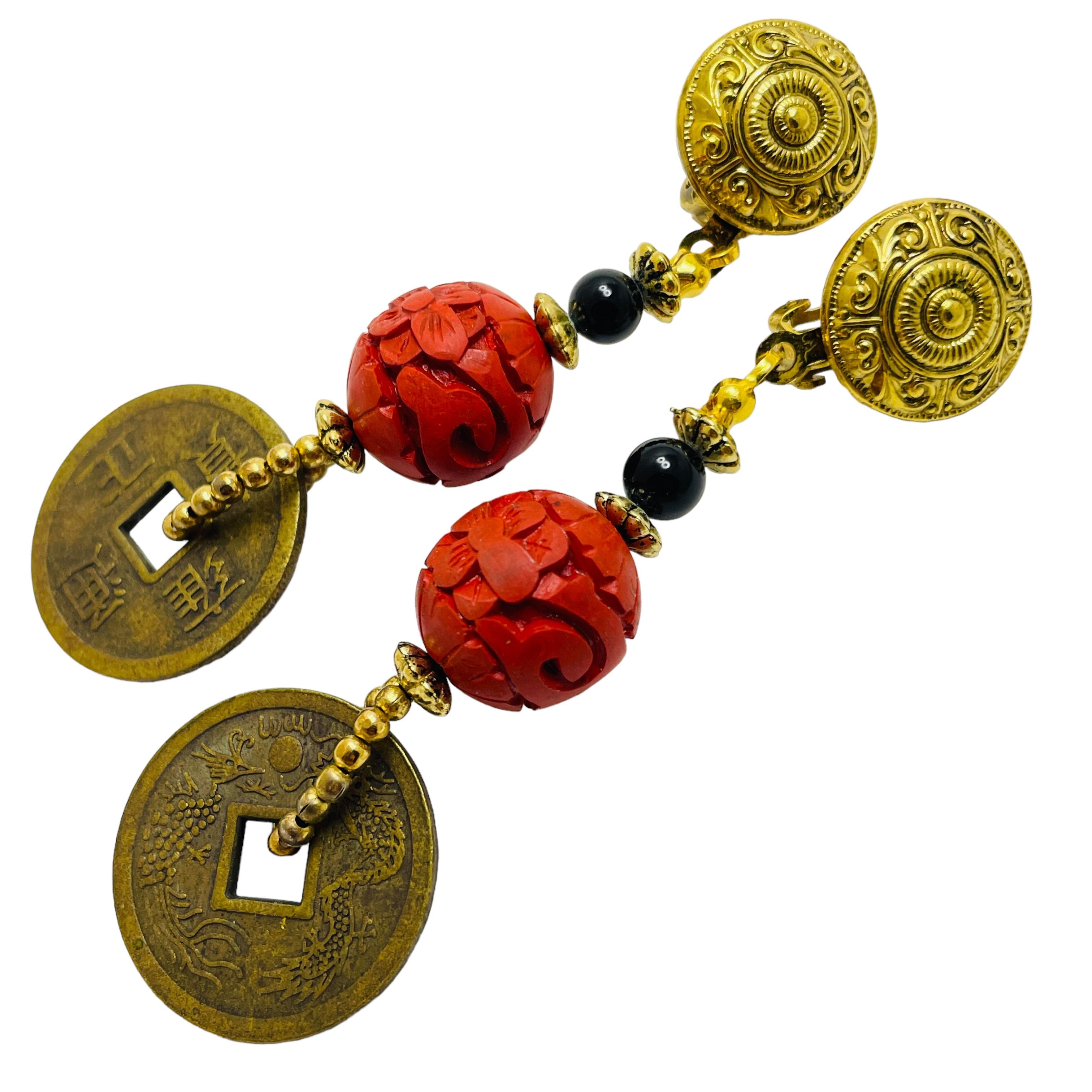DETAILS

• unsigned 

• gold tone with carved cinnabar and old coin

• vintage clip on earrings

MEASUREMENTS  

• 3 1/4