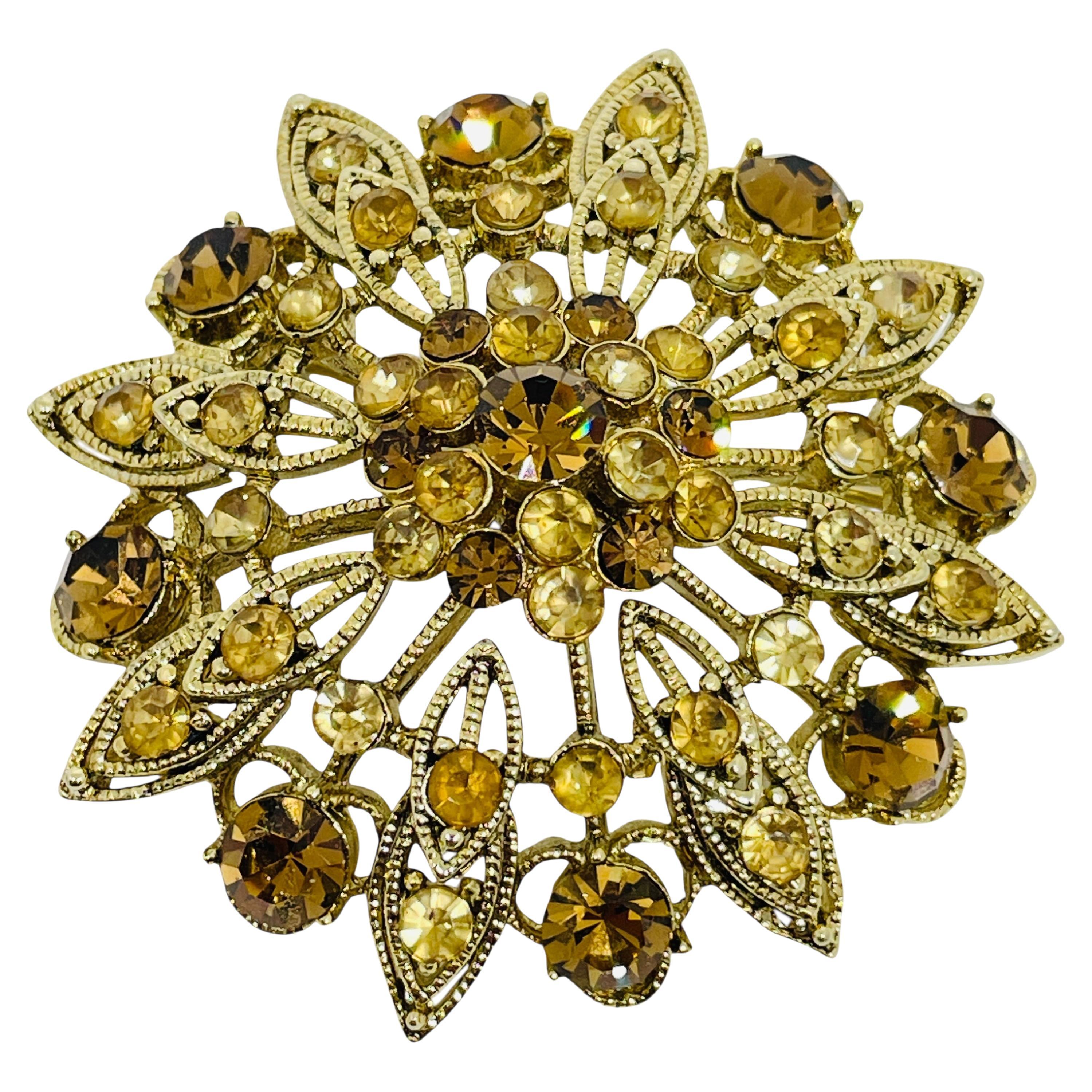 Vintage gold tone rhinestone designer flower brooch