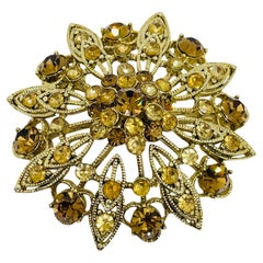 Vintage gold tone rhinestone designer flower brooch