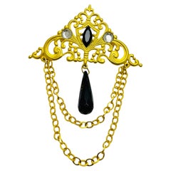 Broche vintage de diseño con brillantitos dorados colgantes