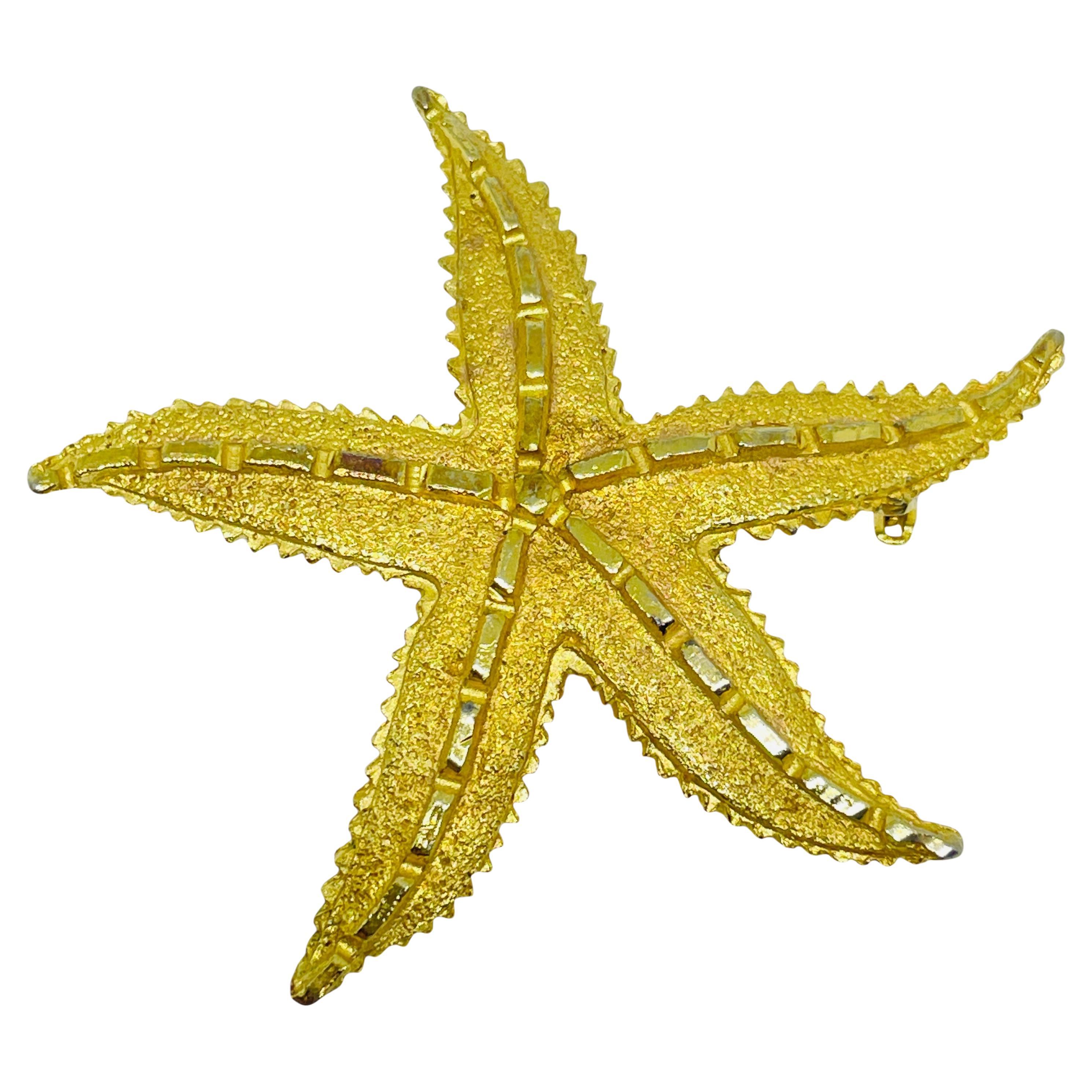 Broche vintage de designer en forme d
étoile de mer dorée