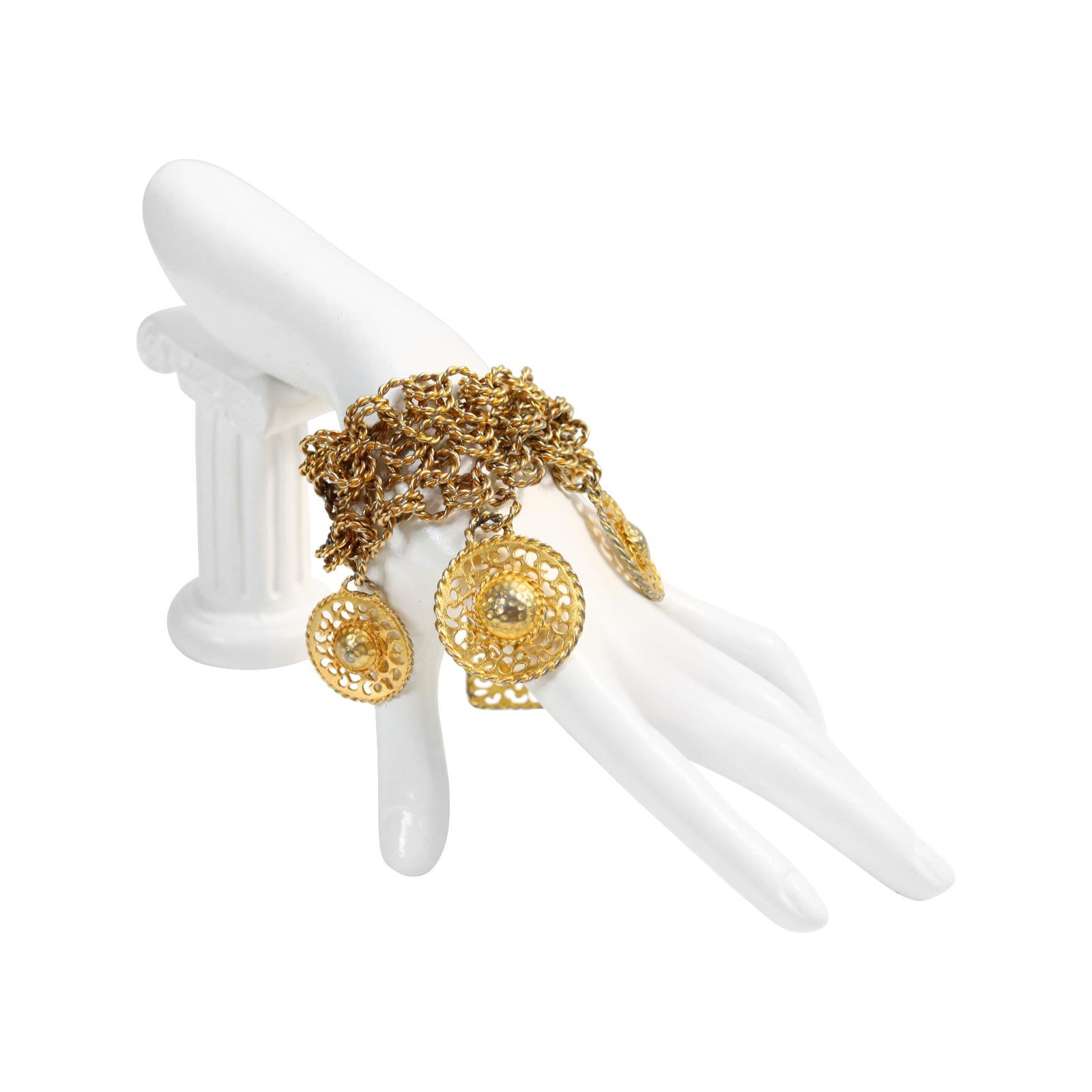 Vintage Gold-Tone Wide Dangling Discs Bracelet, circa 1980s. There are three rows of chains, each with four different designs. It has such a great look on the hand. It can be worn alone or stacked with others like it or even with a resin bracelet