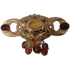 Broche vintage de couleur or avec pierres d'ambre