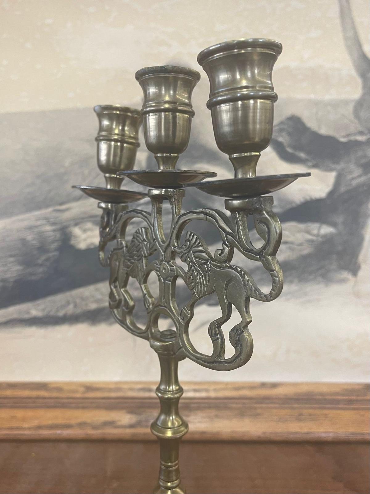 This Candelabra Features a Motif of Two Lions. May need to be Cleaned as Pictured. Vintage Condition Consistent with Age.

Dimensions. 7 W ; 3 D ; 12 H
