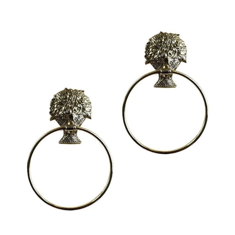 A vintage gold metal flower basket towel ring. A great piece of hardware for a vintage bathroom. This piece features a bouquet of flowers with a round metal ring affixed to the middle for holding towels. Use it in a guest bath or powder room or in a