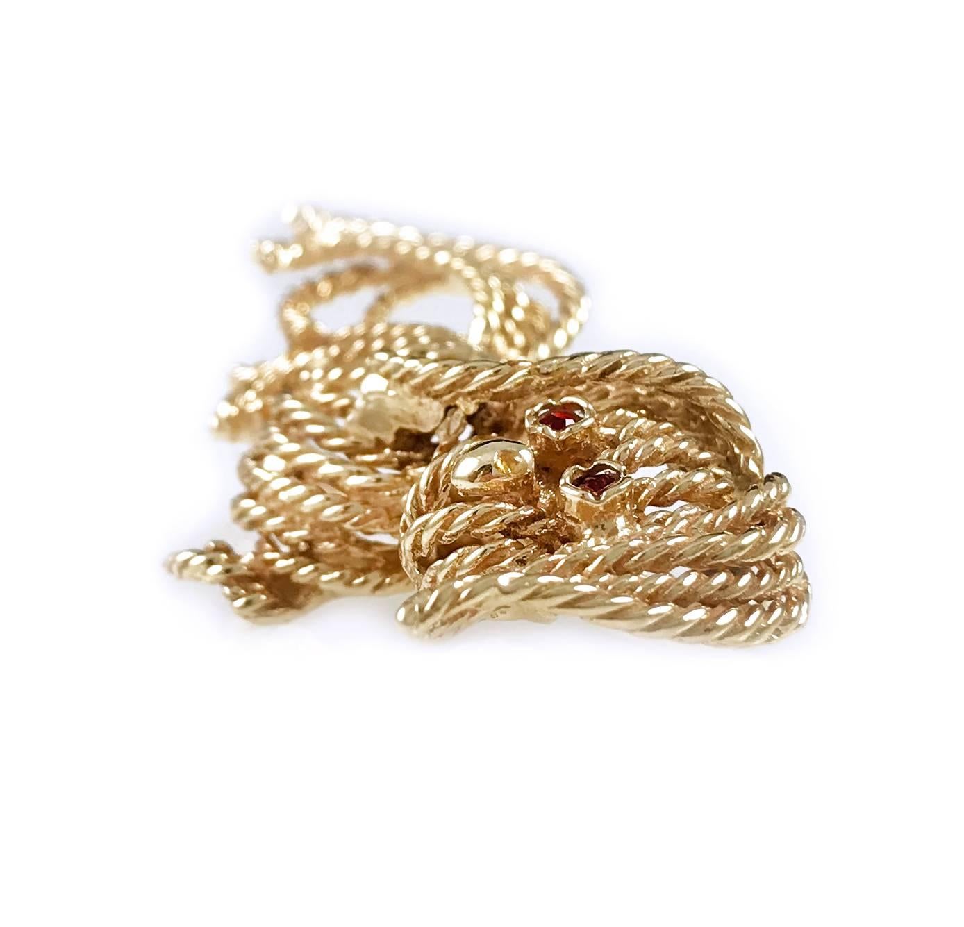 Handmade Vintage 14 Karat Yellow Gold Twisted Wire Dog Brooch. Reminiscent of a Van Cleef & Arpels brooch, this adorable dog brooch has delicate details throughout with a smooth oval nose and round ruby eyes.