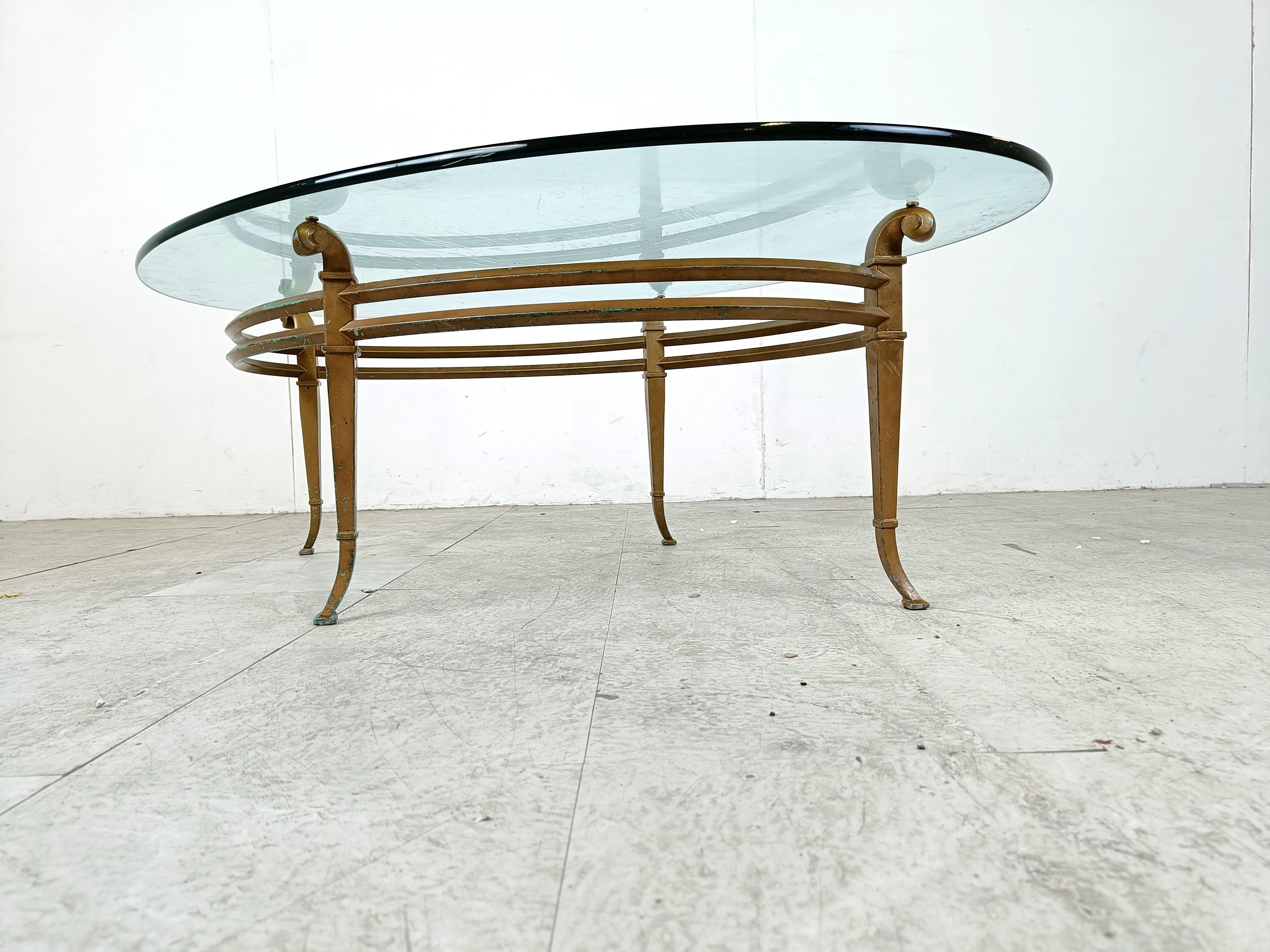 Neoclassical Vintage golden metal and oval glass coffee table, 1970s For Sale