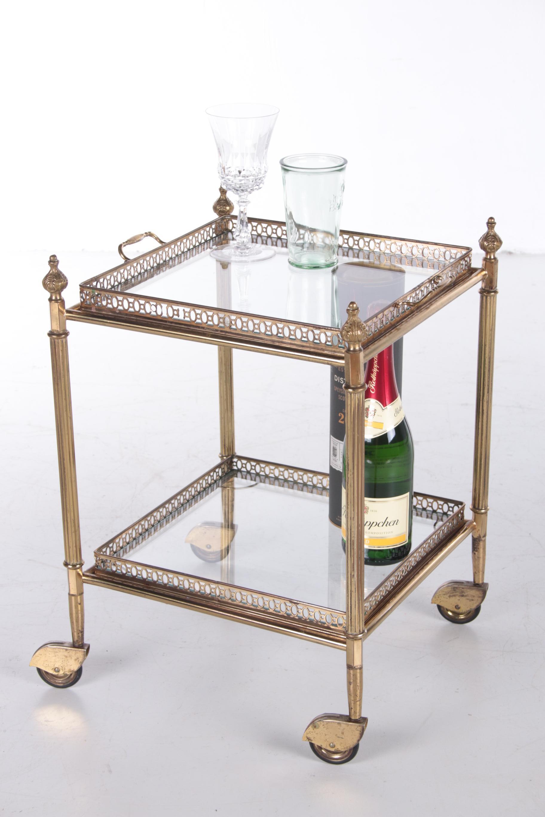 A brass serving trolley/tea trolley vintage with two layers. It has a nice square shape with a brass frame and glass table tops. The top and bottom tops are removable and can also be used as a tray.

Still in beautiful vintage condition. It still
