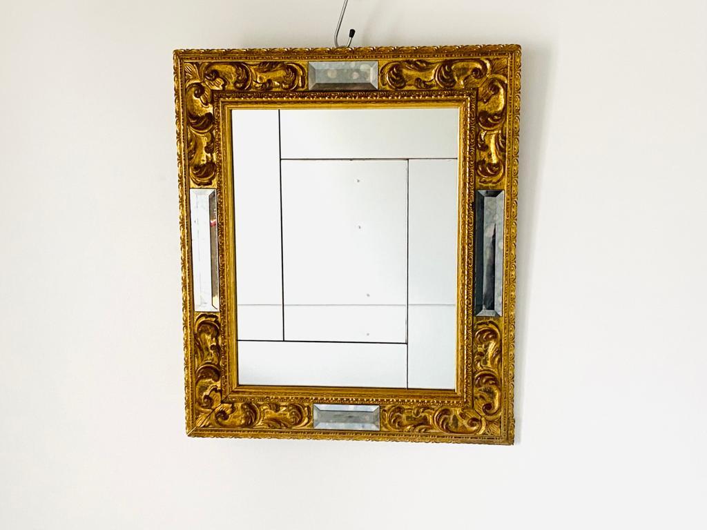 Vintage golden colored rectangular wood  mirror, manufactured in Italy in the 1950s.
A fine 1950s vintage mirror with golden wood frame and fine mirror glass. Italian piece of design recalling classic pattern. In very good conditions with only few