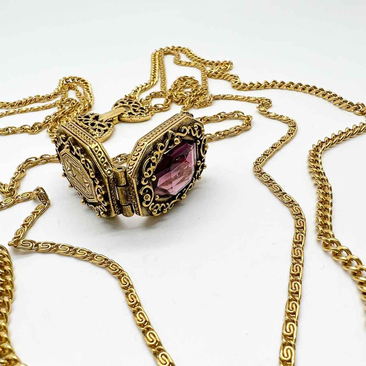 An ultra cool Vintage Goldette Amethyst Locket Chain Necklace. Long triple chains adorned with a fancy opening locket set with an amethyst crystal, inspired by Victorian jewels, makes for a wonderfully cool and chic layering piece.
Goldette started