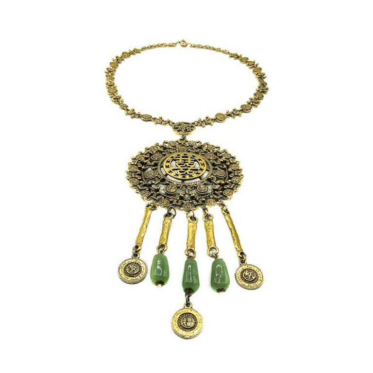 A stunning larger than life Vintage Goldette Chinese Medallion Necklace. Crafted in gold plated metal and with glass faux jade beads on the droplets. Goldette designs are typically highly detailed and whimsical. Drawing upon a myriad of influences