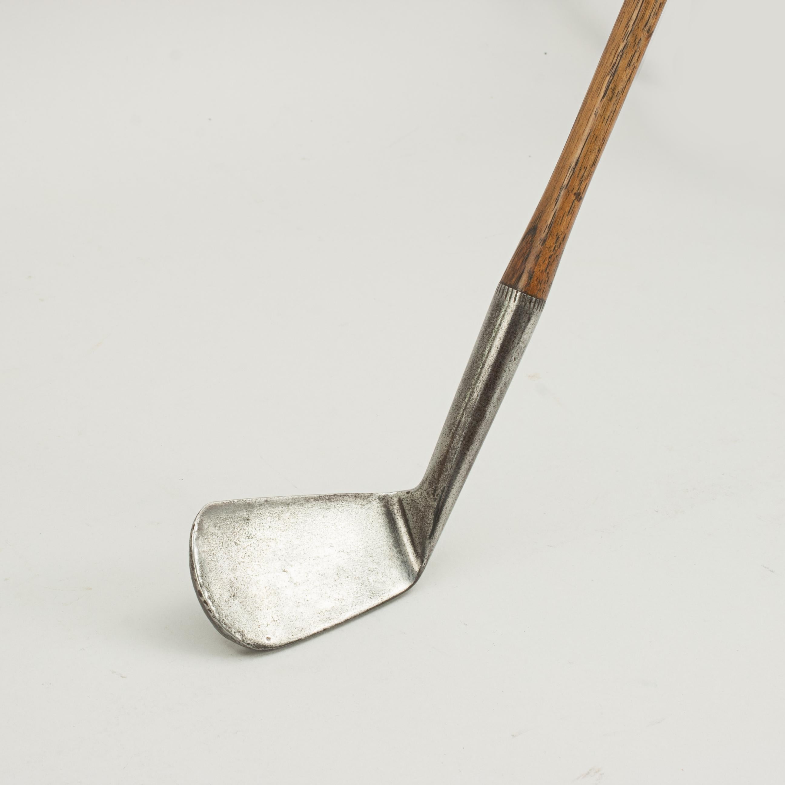 Hickory shafted spalding mashie golf club.
A very nice deep face Mashie with hickory shaft and later rubber type grip by A.G. Spalding & Bros. The smooth face head is stamped to the rear with Spalding's 'Anvil' cleek mark, 'Deep Face Mashie',