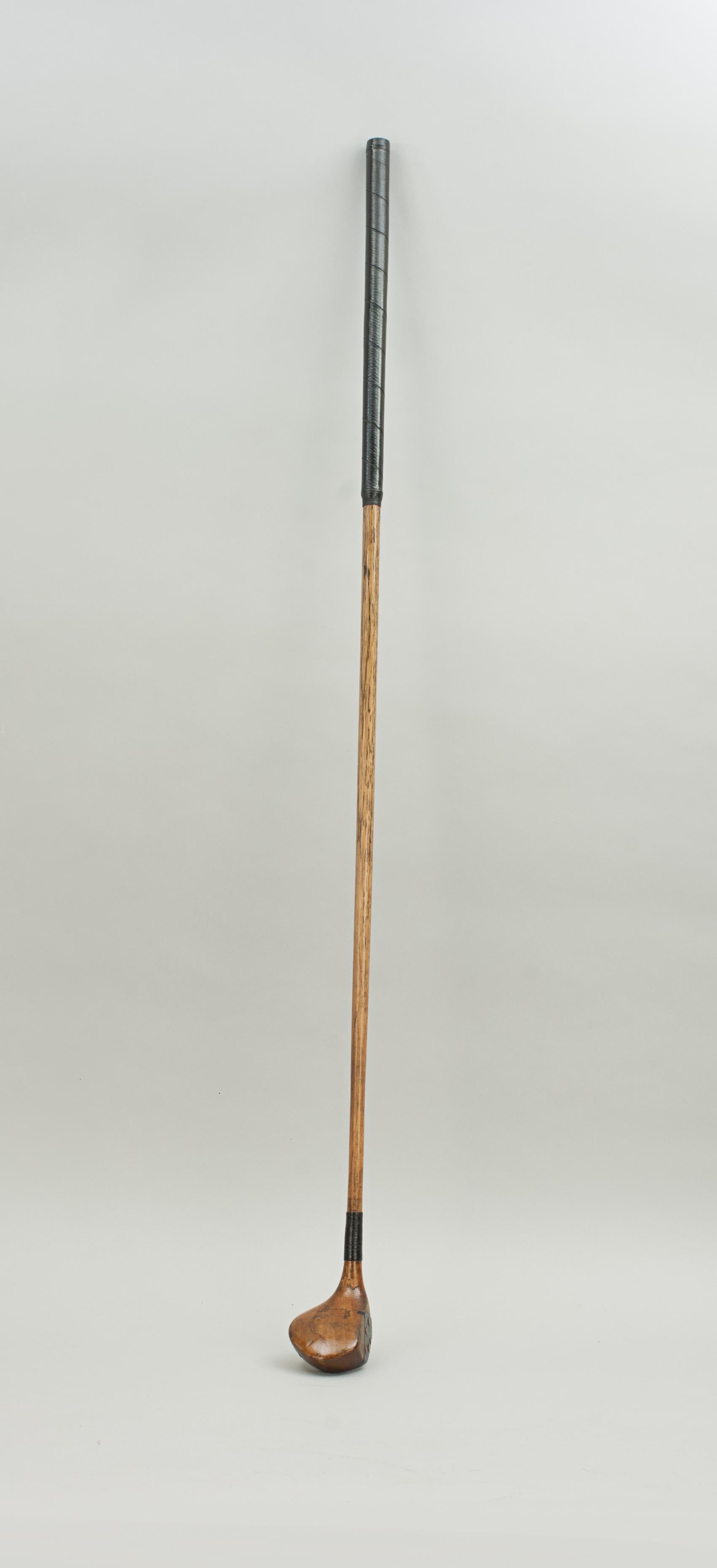 Hickory Shafted Golf Club, Driver.
A small head socket head driver with faint name stamp reading Hardy Bros. 10 Princess St. Edinburgh. The beech-wood head fitted to a hickory shaft with later polished leather grip. Head with lead weight to the