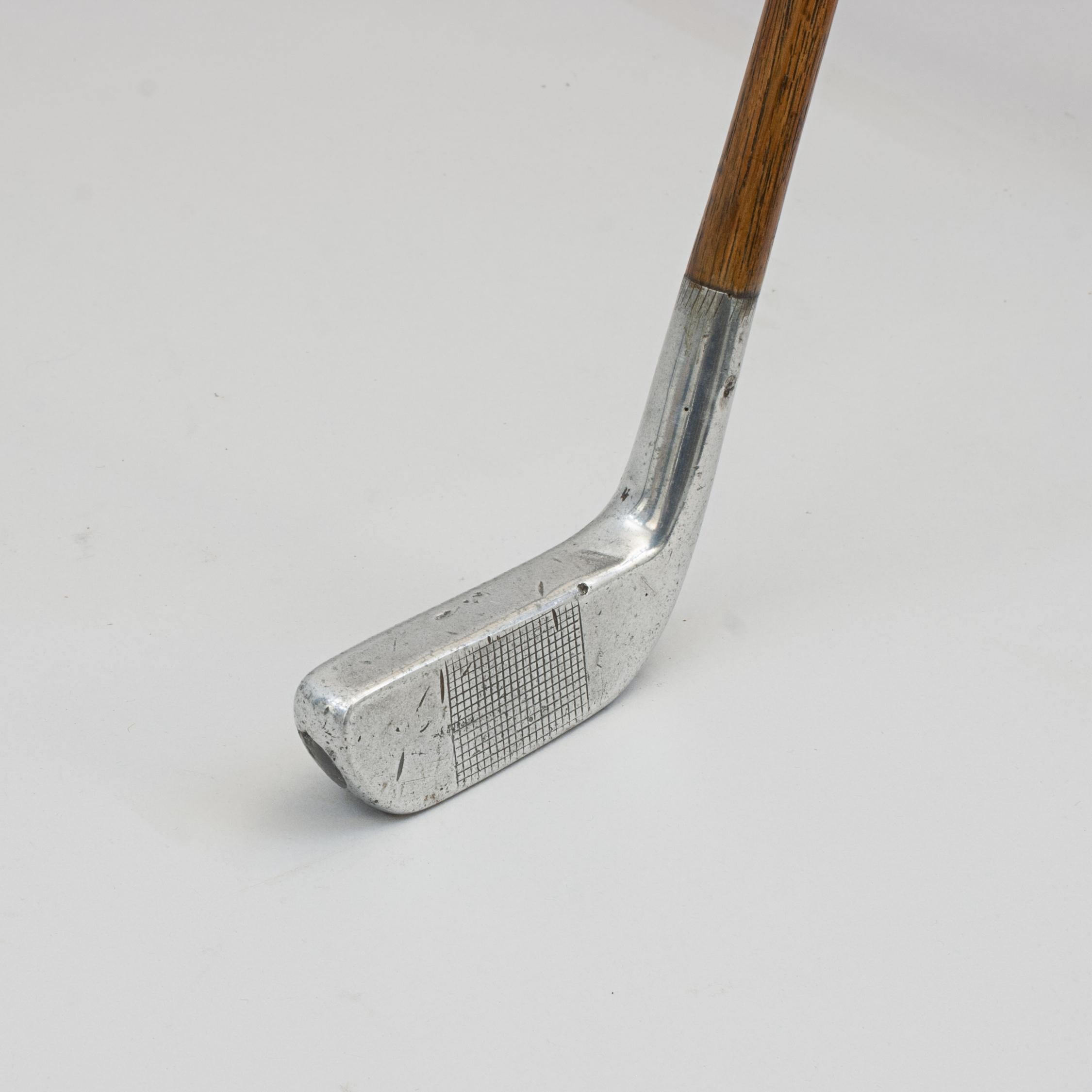 Vintage Aluminium Right-handed putter.
An unusual vintage aluminium putter made by the Imperial Golf Company, Southwick, Sunderland. The golf club face with square mesh pattern, the shaft made of hickory which continues through the hosel with the