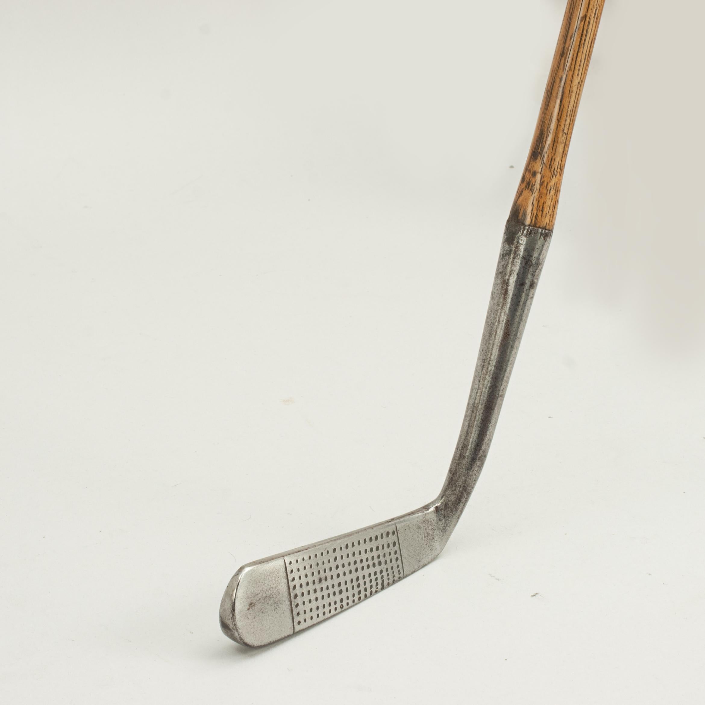 Vintage hickory golf club, putter, Cann & Taylor.
A nice, shallow face blade putter with hand punched dot face markings. The hickory shaft with J. H. Taylor 
